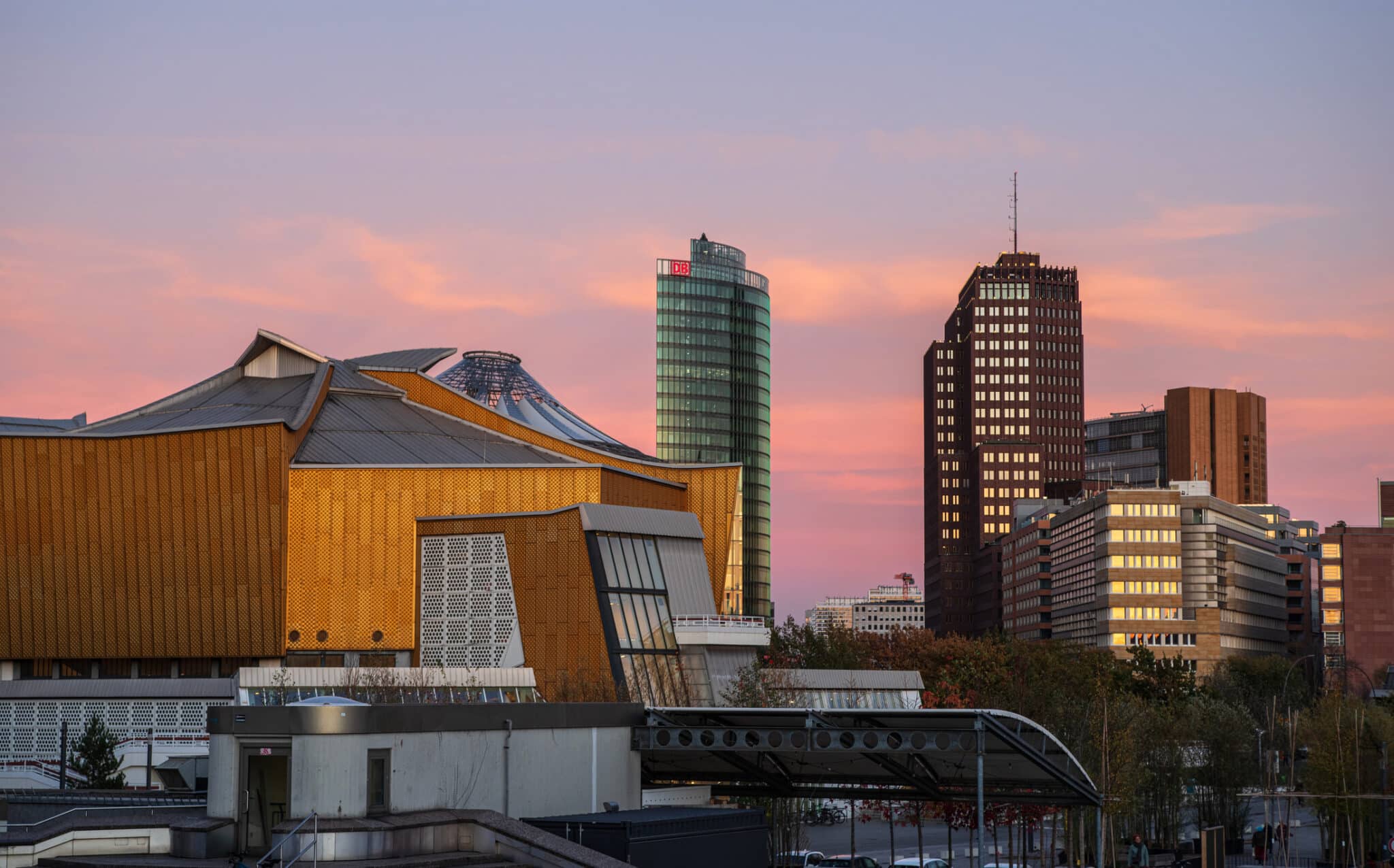 Potsdamer Platz area - buildings of the Berlin Philharmonic Deutsche Bahn Tower Kollhoff-Tower Potsdamer Platz mit der Berliner Philharmonie und modernen Wolkenkratzern bei Sonnenuntergang.